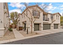 Two story townhome with attached two car garage, walkway and small front yard at 7446 S 30Th Run, Phoenix, AZ 85042