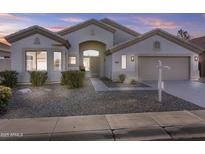 Single-story home with a neutral exterior, landscaping, and a two-car garage at 7983 W Yukon Dr, Peoria, AZ 85382