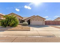 Single-story house with a two-car garage and landscaped front yard at 8833 W Bloomfield Rd, Peoria, AZ 85381