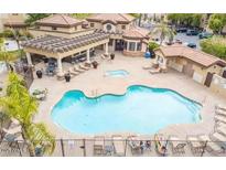Community pool and spa with lounge chairs and covered seating at 10136 E Southern Ave # 1110, Mesa, AZ 85209