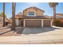 Two-story house with three-car garage and desert landscaping at 10359 W Sunflower Pl, Avondale, AZ 85392