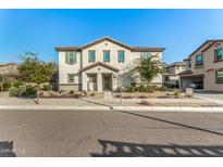 Two-story house with light-colored exterior, landscaping, and a gated entryway at 11695 N 166Th Ln, Surprise, AZ 85388