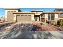 Charming single-Gathering home with a three-car garage and a well-maintained, xeriscaped front yard at 13855 S 181St Ave, Goodyear, AZ 85338