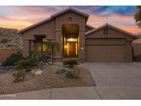 Desert landscaping and a tan stucco exterior enhance this single-story home at 15632 S 6Th St, Phoenix, AZ 85048