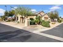 Charming home exterior featuring desert landscaping, a tile roof, and a well-maintained yard at 15738 W Clear Canyon Dr, Surprise, AZ 85374