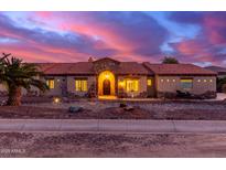 Stunning ranch house exterior at sunset, featuring a tile roof and stone accents at 18509 W Bethany Home Rd, Litchfield Park, AZ 85340