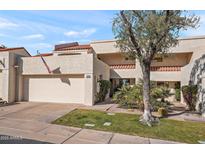 Tan two-story home with attached garage and nicely landscaped front yard at 2430 E Palo Verde Dr, Phoenix, AZ 85016