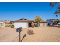 Single-story home with a two-car garage and desert landscaping at 2454 W Hearn Rd, Phoenix, AZ 85023