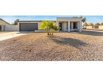 Newly renovated home with modern facade, two-car garage, and desert landscaping at 3301 E Larkspur Dr, Phoenix, AZ 85032