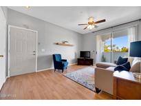 Bright living room with wood floors, comfy seating, and sliding door to balcony at 3302 N 7Th St # 366, Phoenix, AZ 85014