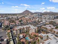 Aerial view of community, pool, and city views at 4200 N Miller Rd # 526, Scottsdale, AZ 85251