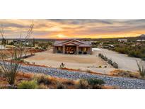 Aerial view of a single-story house with desert landscaping and a large yard at 5063 E Reavis St, Apache Junction, AZ 85119