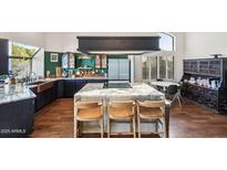 Modern kitchen with granite countertops and a farmhouse sink at 5582 W Aster Dr, Glendale, AZ 85304