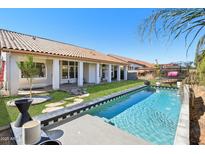 Inviting backyard pool with a covered patio and ample space for entertaining at 5582 W Aster Dr, Glendale, AZ 85304