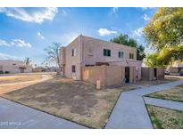 Two-story stucco building with a gated entry and landscaped yard at 600 S Dobson Rd # 166, Mesa, AZ 85202