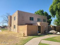 Two-story stucco building with gated entry and a landscaped yard at 600 S Dobson Rd # 166, Mesa, AZ 85202