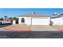 Single-story home with attached garage and desert landscaping at 7456 W Greer Ave, Peoria, AZ 85345