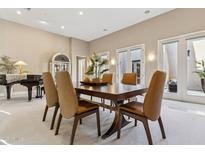 Elegant dining room features a large wood table, comfortable seating, and access to a backyard patio at 8534 E Angel Spirit Dr, Scottsdale, AZ 85255