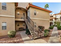 Attractive exterior of a two-story condo building with stairs and landscaping at 10410 N Cave Creek Rd # 2060, Phoenix, AZ 85020