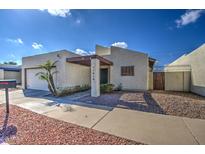 Tan stucco house with a single car garage and walkway at 11616 N 30Th Ln, Phoenix, AZ 85029