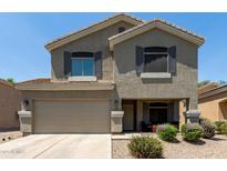Charming two-story home featuring a two-car garage and a welcoming front porch at 12378 W Roma Ave, Avondale, AZ 85392