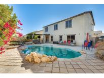 Inviting backyard oasis featuring a sparkling pool and patio at 14206 W Mandalay Ln, Surprise, AZ 85379