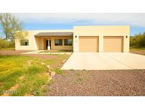 Single-story home with two-car garage and desert landscaping at 1628 E Magellan Dr, New River, AZ 85087