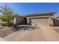 Single-story home with a two-car garage and well-manicured landscaping at 1866 N 214Th Ln, Buckeye, AZ 85396