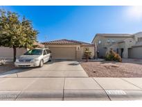 Single-story home with a two-car garage and desert landscaping at 18927 N Leland Rd, Maricopa, AZ 85138