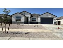 One-story house with a two-car garage and desert landscaping at 25570 N 154Th Ln, Surprise, AZ 85387