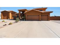 Two-story house with a three-car garage and desert landscaping at 2837 N Whiting Cir, Mesa, AZ 85213