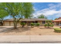 Ranch style home with landscaped yard and two-car garage at 3136 W Sunnyside Ave, Phoenix, AZ 85029