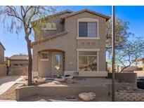 Two-story house with neutral exterior, landscaping, and a two-car garage at 7235 E Norwood St, Mesa, AZ 85207