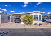 Single-wide manufactured home with carport and landscaped yard at 7750 E Broadway Rd # 684, Mesa, AZ 85208