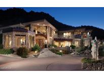 Luxury home with stone exterior, large windows, and dramatic mountain views at 8060 N Mummy Mountain Rd, Paradise Valley, AZ 85253