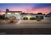 Charming single-Gathering home with a well-manicured lawn, inviting curb appeal, and covered entrance at 8531 E Laredo Ln, Scottsdale, AZ 85250