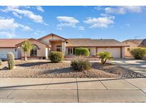 Single-story home with a two-car garage and desert landscaping at 13907 W Gable Hill Dr, Sun City West, AZ 85375