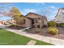 Charming single-story home with well-maintained landscaping and inviting curb appeal at 14765 W Alexandria Way, Surprise, AZ 85379