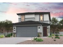 Two-story home with gray exterior, dark roof, and stone accents at 17313 W Jessie Ln, Surprise, AZ 85387