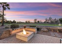 Backyard fire pit with seating area, overlooking a golf course at 22454 N San Ramon Dr, Sun City West, AZ 85375