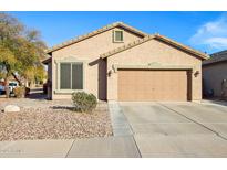 Charming single-story home featuring a two-car garage, desert landscaping, and a cozy front facade at 261 N Nash Way, Chandler, AZ 85225