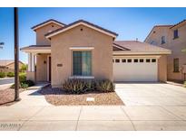Charming single-Gathering home with a well-maintained lawn, a two-car garage, and desert landscaping at 263 W Rosemary Dr, Chandler, AZ 85248