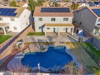 Aerial view of two-story house with solar panels, pool, and desert landscaping at 30293 W Mitchell Ave, Buckeye, AZ 85396