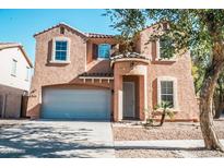 Two-story house with a large garage and desert landscaping at 7 N 87Th Dr, Tolleson, AZ 85353
