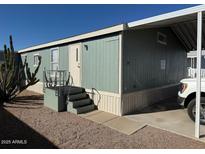 Mobile home exterior features a carport and steps leading to the front door at 8832 E Pueblo Ave # 29, Mesa, AZ 85208