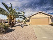 Single-story house with a two-car garage and desert landscaping at 11422 W Pinehollow Dr, Surprise, AZ 85378