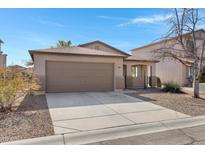 Single-story house with a two-car garage and desert landscaping at 1195 E Dust Devil Dr, San Tan Valley, AZ 85143