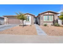 Single-story home with a two-car garage and desert landscaping at 1238 W Silver Creek Ln, San Tan Valley, AZ 85140