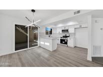 Modern kitchen with white cabinets, stainless steel appliances, and an island at 1387 N 44Th St, Phoenix, AZ 85008