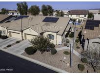 Aerial view of a house with solar panels and a two-car garage at 1548 E Melrose Dr, Casa Grande, AZ 85122